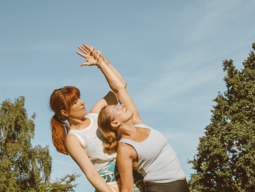 Julia and a student practice yoga in Bedford Park